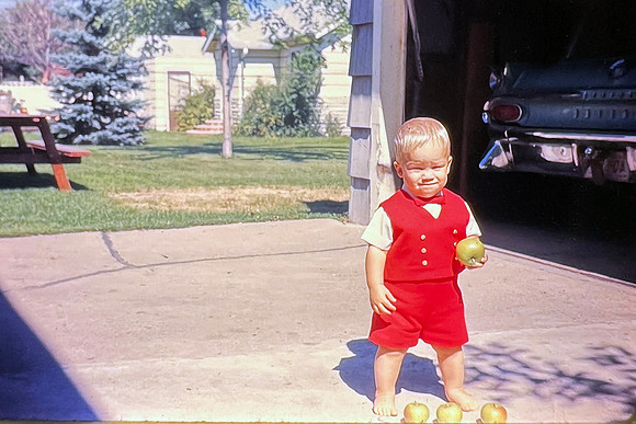 19660400 Erik holding apple in red suit
