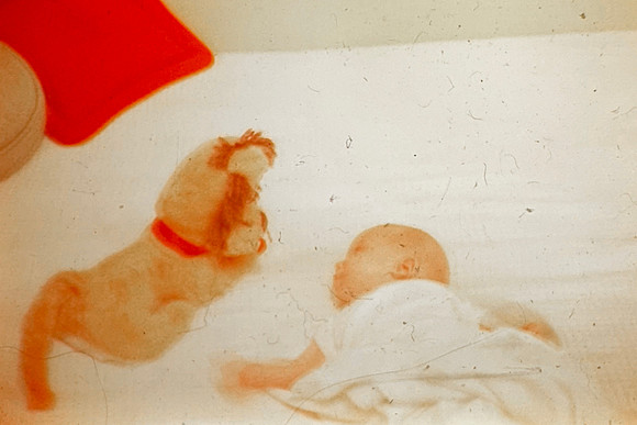 19650900 Erik looking at stuffed dog